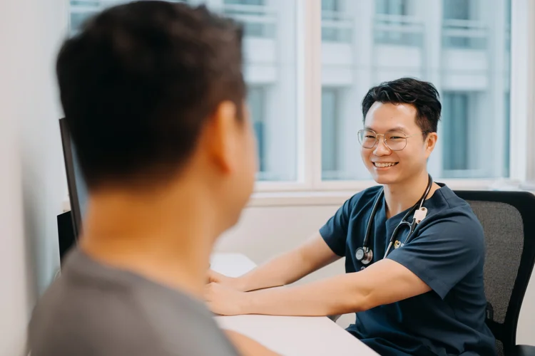 Dr Leonard Leng consulting a patient at the clinic in Singapore